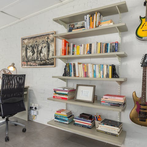 Catch up on work in the mezzanine office area with its books and guitars