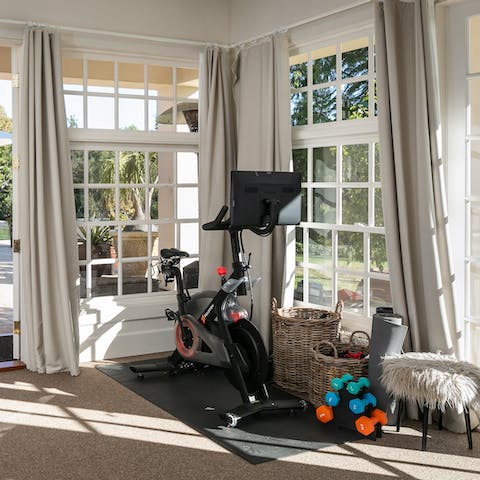 Do a home fitness session on the peloton, before heading outside to relax around the pool 