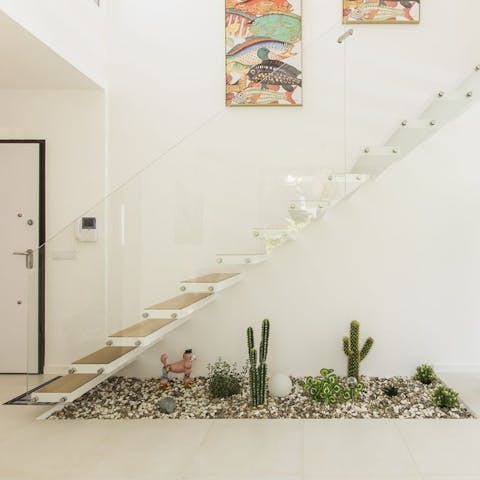 Admire the quirky indoor garden under the floating staircase