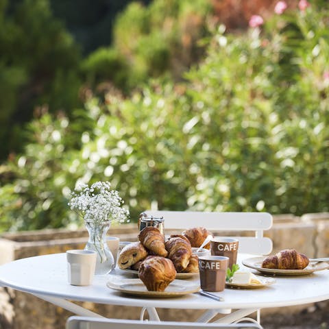 Start the day with coffee and croissants at the breakfast table outside
