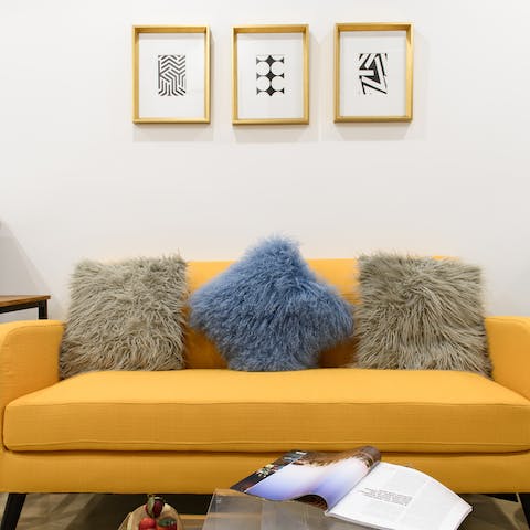 Snuggle up on the mustard yellow sofa with a glass of wine after a day of exploring the city