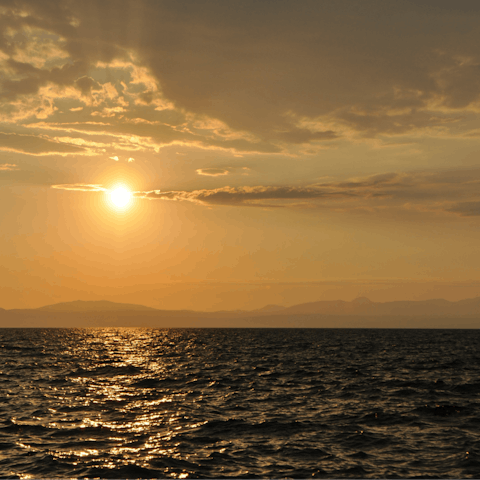 Watch the sunset at Paralia Kalamatas, a short drive from home