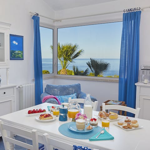 Gaze out of the corner window in the dine-in kitchen at the sparkling sea