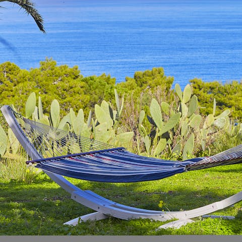 Catch up on holiday reading in the hammock with the sea view