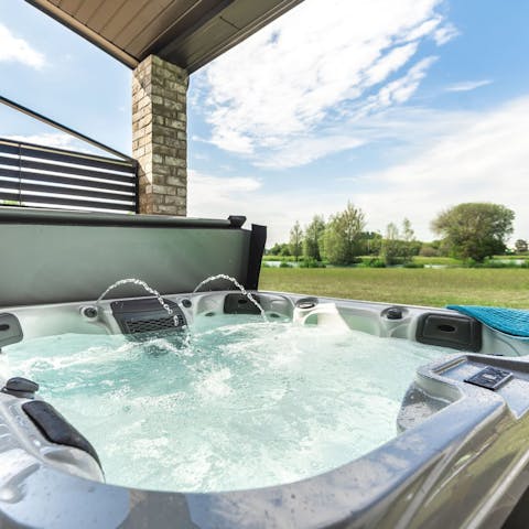 Unwind in the bubbling hot tub on summer evenings