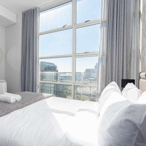 Wake up to sprawling cityscape views from your plump bed