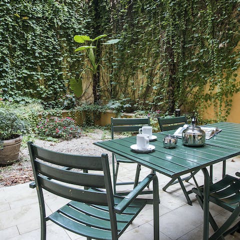 Open a bottle of wine and relax on the ivy-covered patio