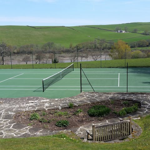 Challenge all comers to a game or two on the private tennis court