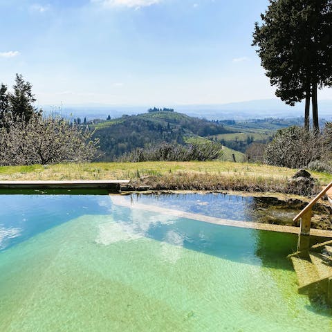 Take a dip in the natural pool with views of the Tuscan hills