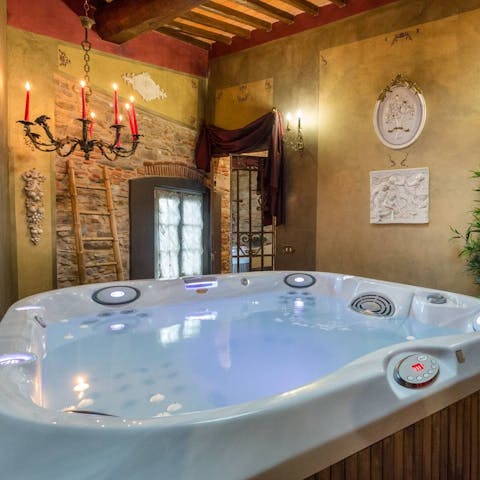 Enjoy a relaxing soak in the private hot tub, a glass of bubbly in hand