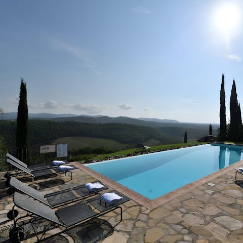 Swim in the communal pool as countryside views stretch before you