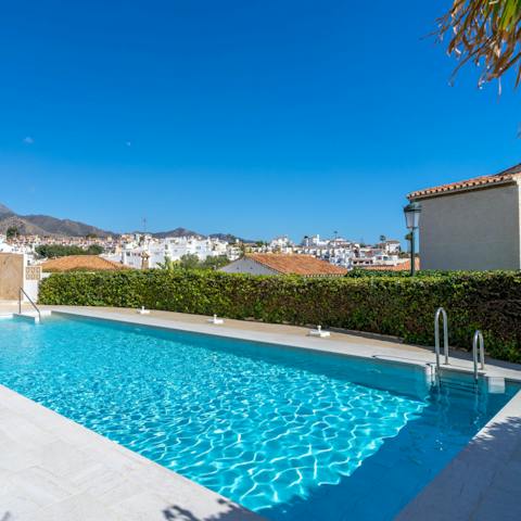 Enjoy a cooling swim under the Spanish sun in the shared outdoor pool