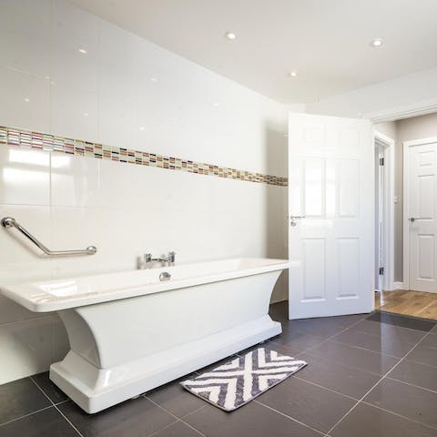 Enjoy the accessible features in the main bathroom, including an open shower and safety rails