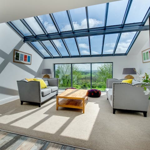 Relax in the light-filled living room with its Welsh countryside vistas