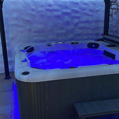 Unwind with a glass of wine in the colourful hot tub