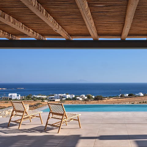 Sit back and look out at the breathtaking Aegean horizon, drink in hand