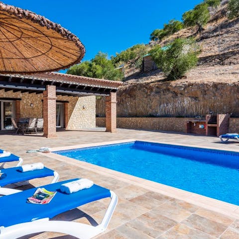 Unwind with a bottle of wine by the pool under the sun