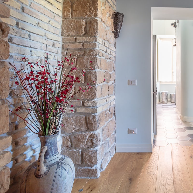 Admire how the home's design incorporates the city's historic roots through exposed brick walls and terracotta accessories