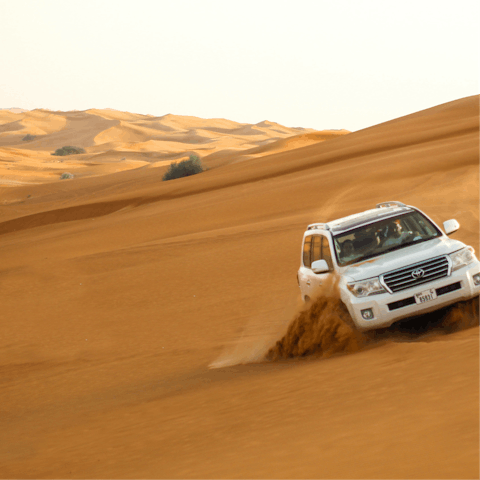 Book an adrenaline-fuelled dune bashing tour in a 4X4