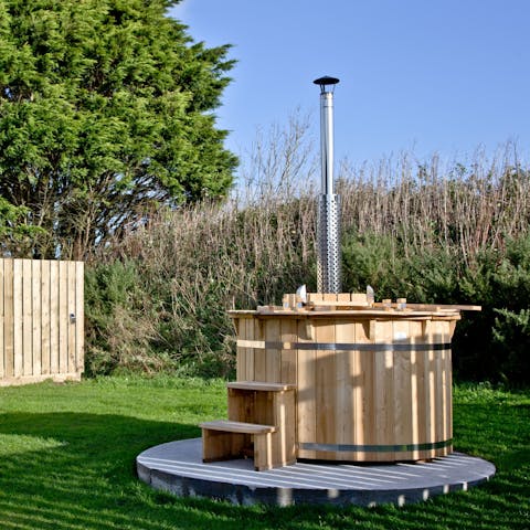 Soothe your aching muscles in the wood-fired hot tub after a long day out experiencing the best of the Cornish coast