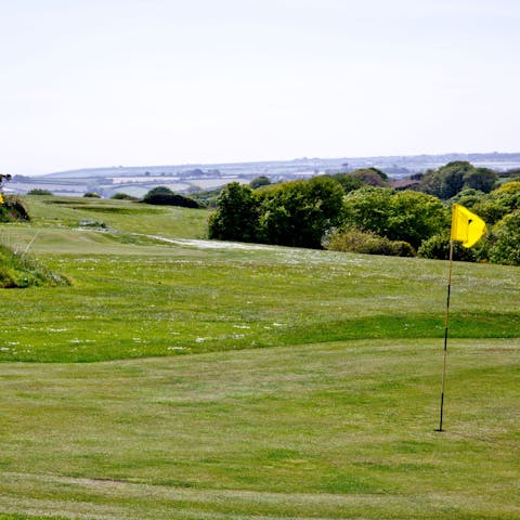 Tee off at the nine-hole on-site golf course