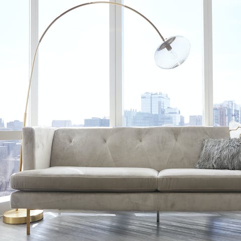 Recline with a cup of coffee in your sleek and bright living space