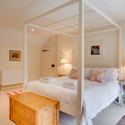 Slumber in style in the superbly modern four-poster bed