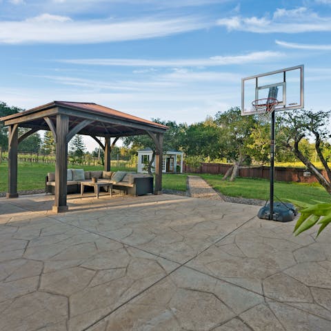 Seek out a shaded spot beneath the pergola, play games on the patio, or relax in the secluded summerhouse