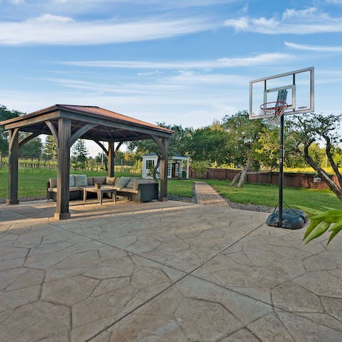 Seek out a shaded spot beneath the pergola, play games on the patio, or relax in the secluded summerhouse