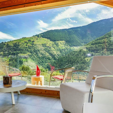 Curl up on the armchair while you gaze out at the mountains