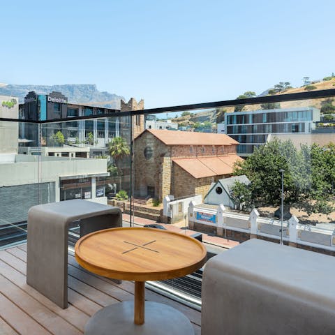 Take in the views over the city and mountains from the private balcony