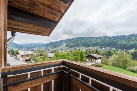 Enjoy balcony views of wooded-mountain slopes