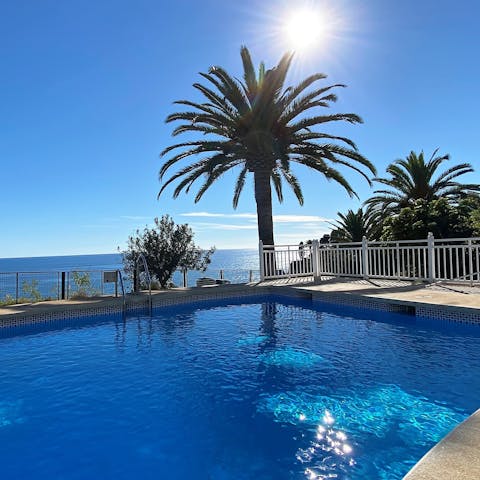 Swim in the communal pool as you enjoy the sun and sea views