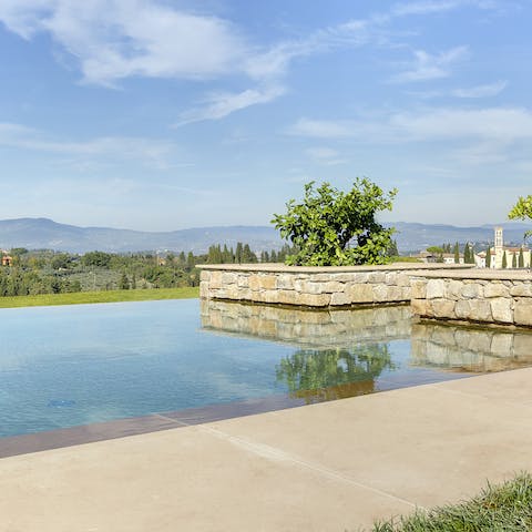 Enjoy a few leisurely strokes of your infinity pool overlooking the Tuscan hills