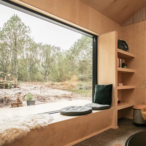Curl up on the window seat and admire the views of the forest outside