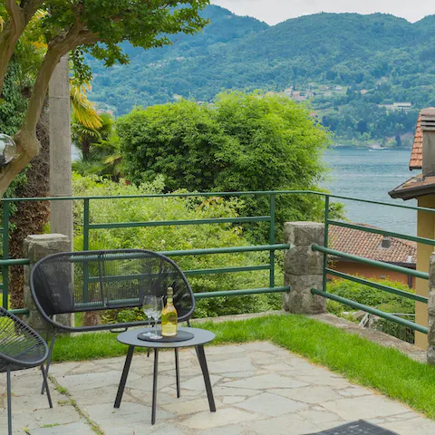 Enjoy an Italian aperitif on the patio with a lakeside view