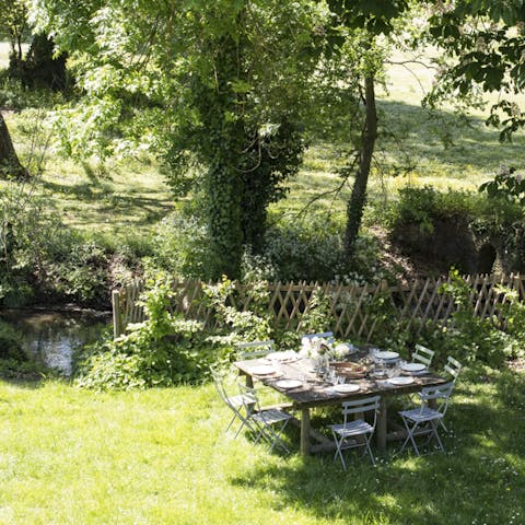 Enjoy afternoon tea under the shade of ancient oaks by the river