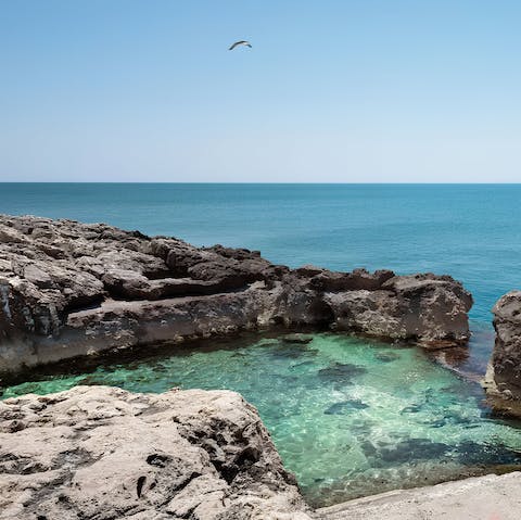 Take a dip in the natural pool's crustal-clear sea waters 