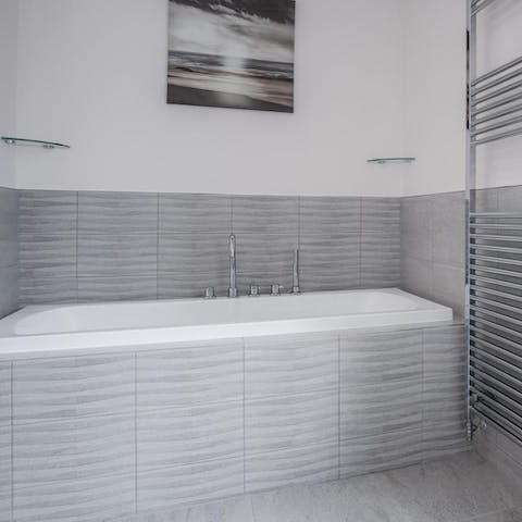 Unwind with a relaxing bubble bath in the luxurious bathroom