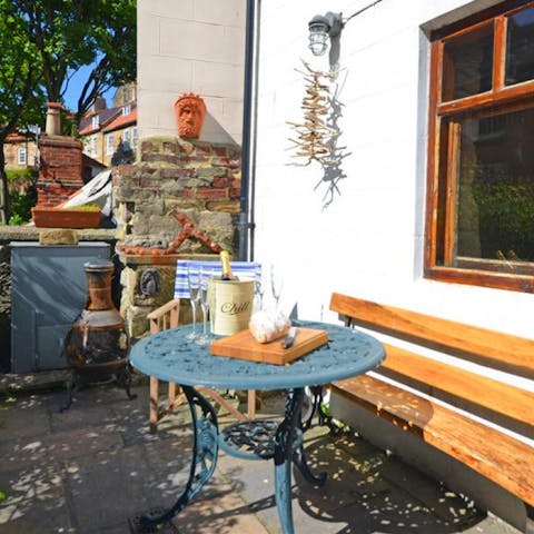 Enjoy a drink in the rustic, suntrap patio garden