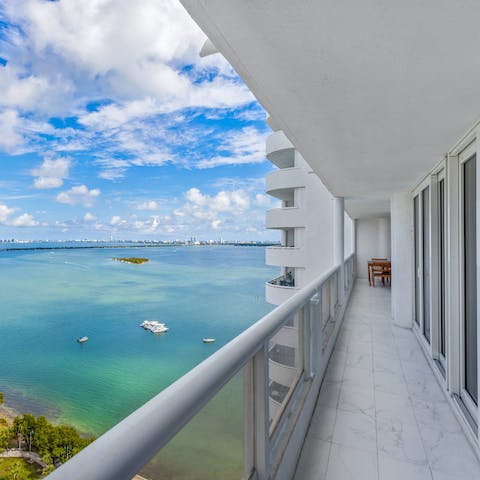 Watch the sunset over Biscayne Bay from your balcony with a glass of wine in hand