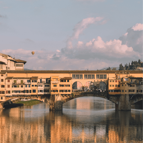 Admire the work of artisans while strolling across Ponte Vecchio