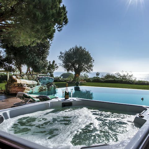 Unwind in the hot tub after a refreshing swim in the private pool
