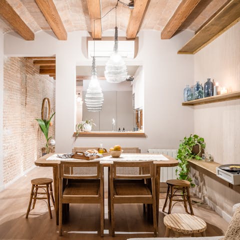 Sit down to group meals in the curated dining area with Catalan-style beams and houseplants