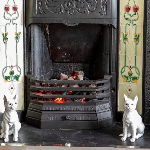 Cosy up by the original fireplace