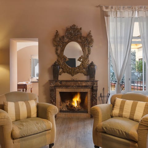 Stay warm and cosy by the fireplace in cooler months