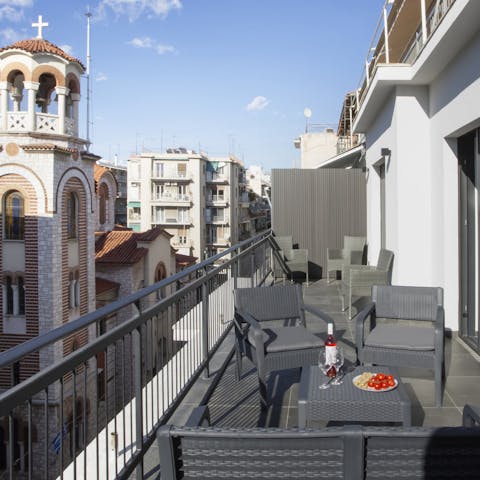 Relax with a glass of Greek wine on the private balcony