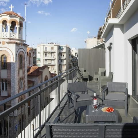 Relax with a glass of Greek wine on the private balcony