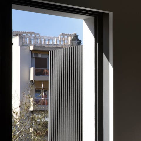Take in the glimpses of the Acropolis from the living space