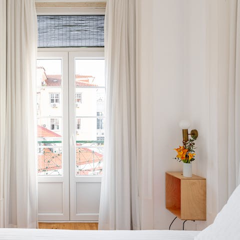Wake up to beautiful views of central Lisbon from the bedroom's Juliet balcony